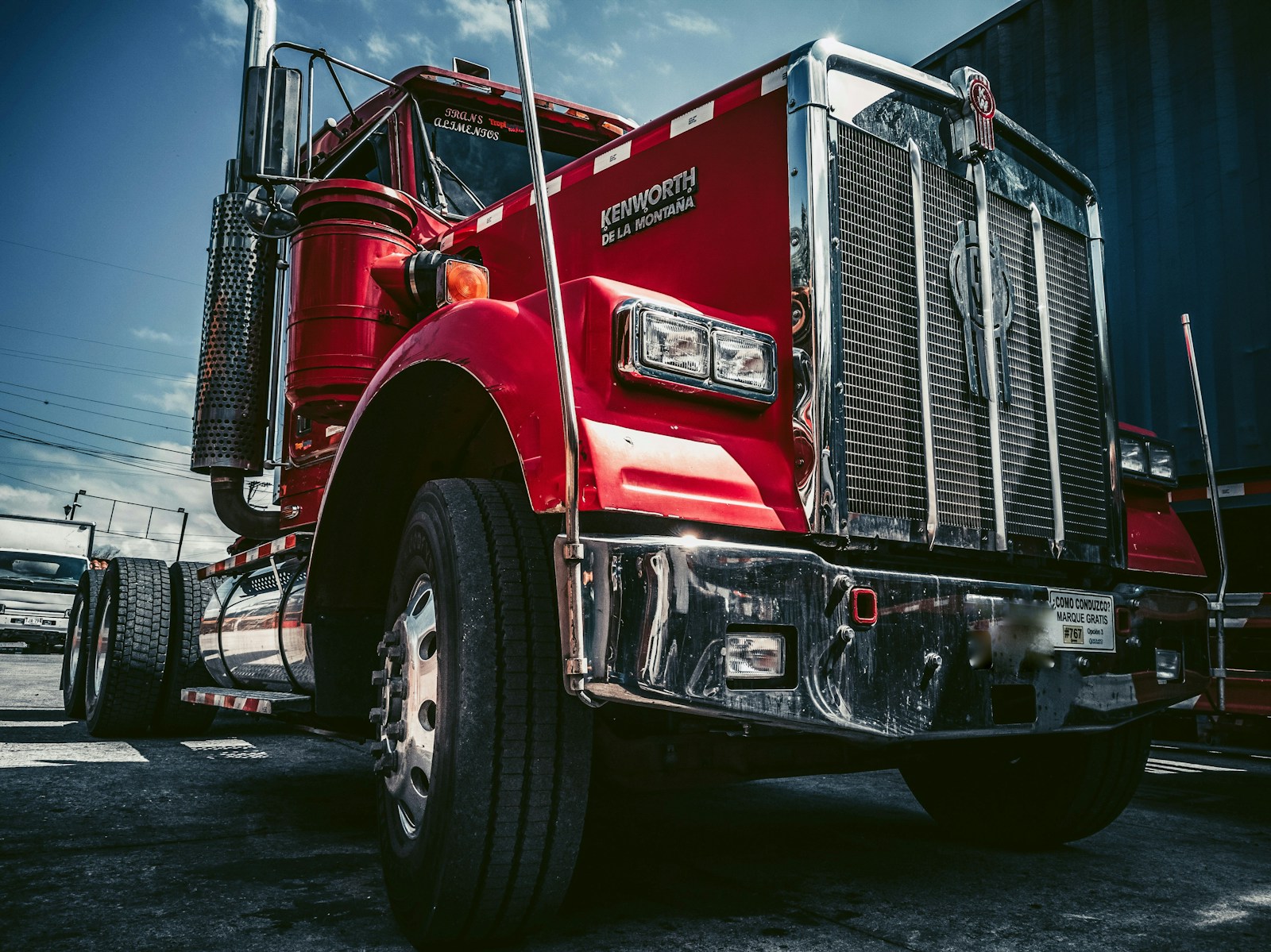 red and white truck on black asphalt road with trucking insurance